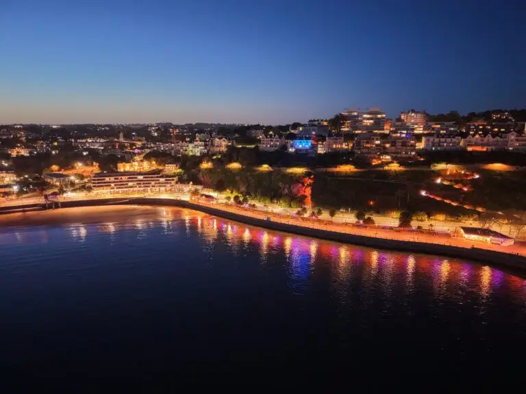 Drone image taken at night showing lights on coastline. Still taken from drone video.